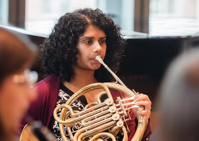 Student playing horn