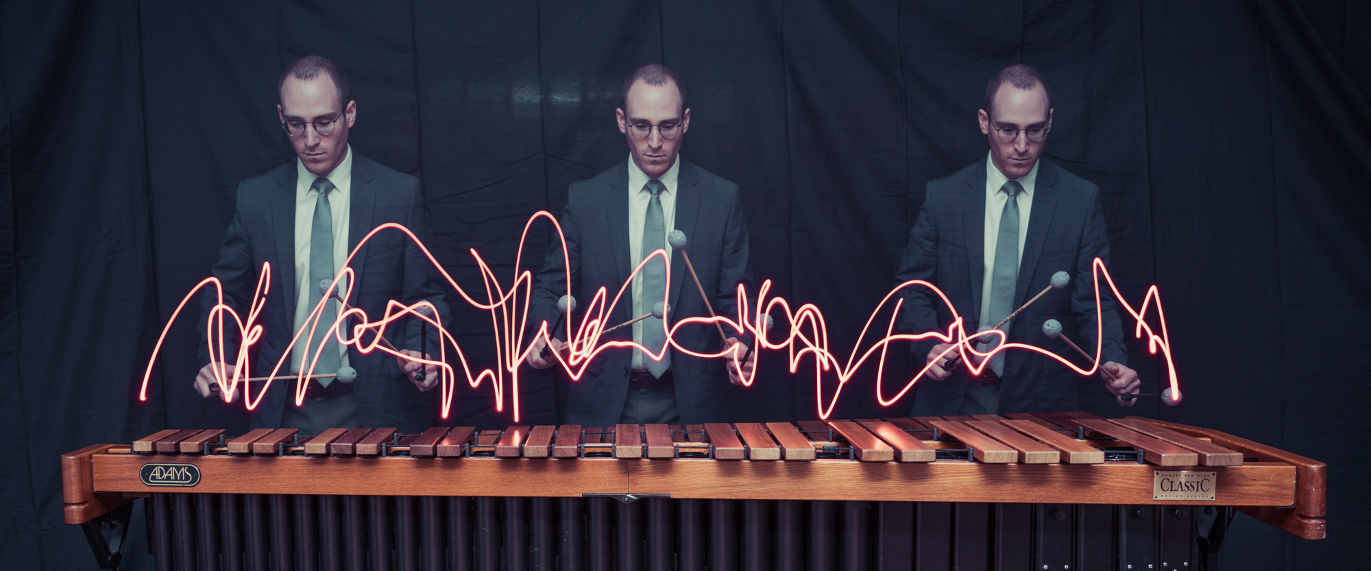 Three men playing percussion