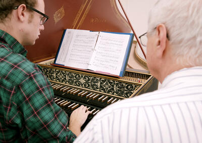 Student and teacher at harpsichord