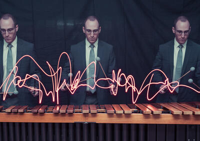 Three men playing percussion